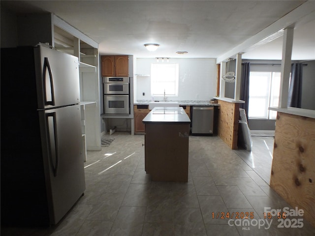 kitchen featuring sink, a kitchen island, and appliances with stainless steel finishes