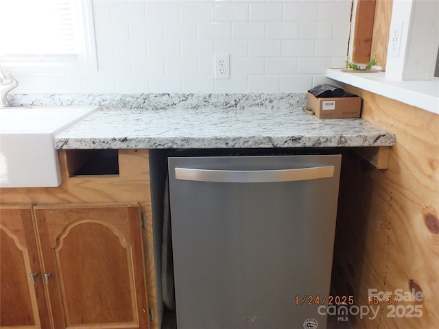 room details featuring tasteful backsplash, stainless steel dishwasher, and sink