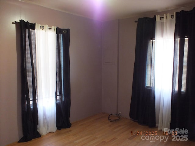 unfurnished room with plenty of natural light and light hardwood / wood-style flooring