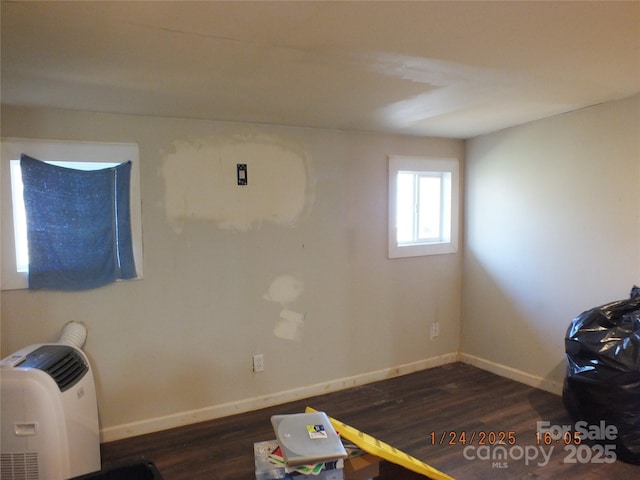 miscellaneous room featuring dark wood-type flooring