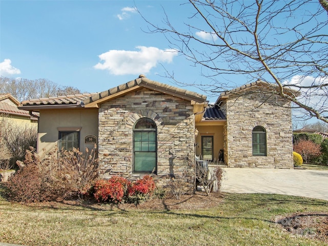 mediterranean / spanish-style home with a front lawn