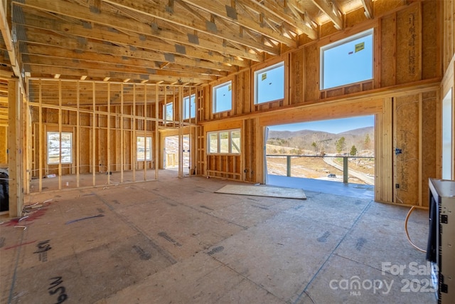 miscellaneous room with a mountain view and a high ceiling