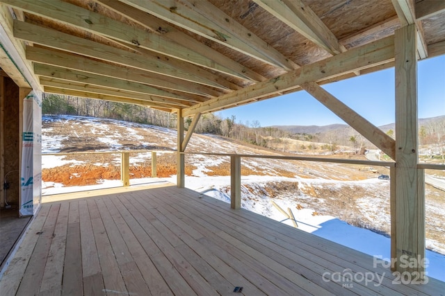 snow covered deck featuring a mountain view