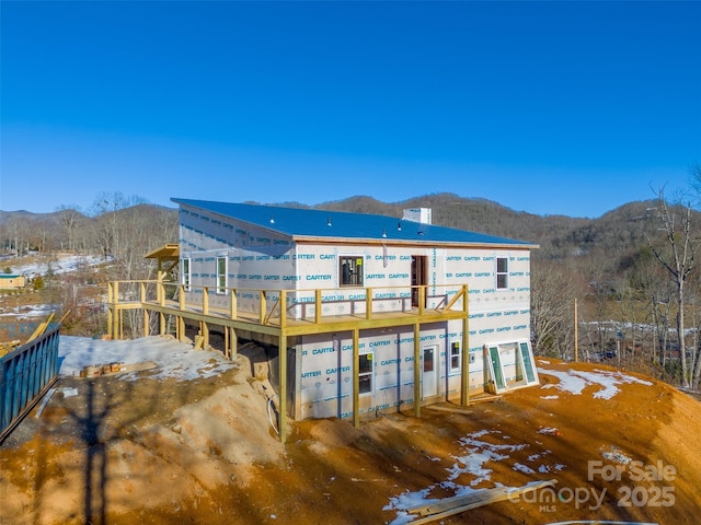 snow covered property featuring a mountain view