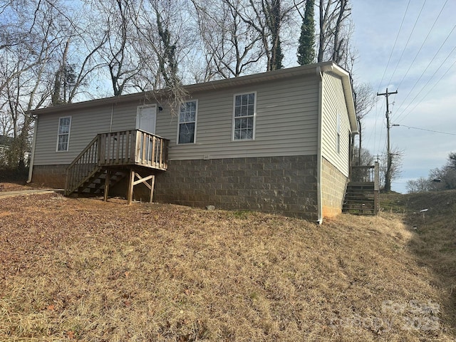 back of property with a wooden deck