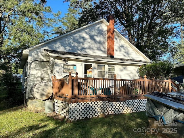 back of house featuring a deck