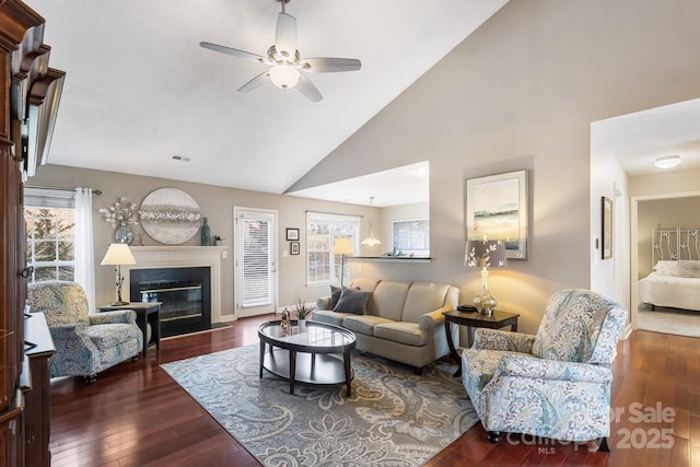 living room with ceiling fan, dark hardwood / wood-style floors, and high vaulted ceiling