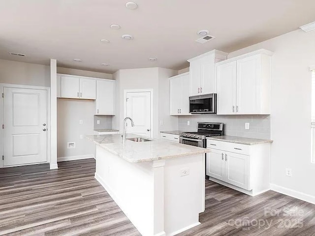 kitchen with white cabinetry, sink, an island with sink, and appliances with stainless steel finishes