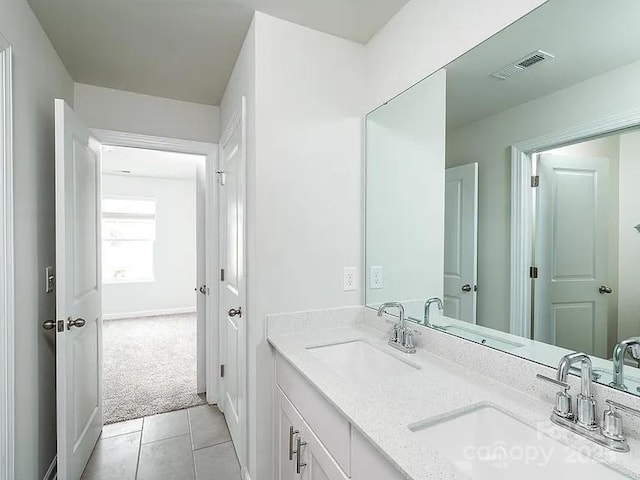 bathroom with tile patterned floors and vanity