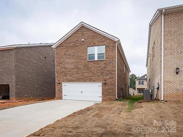 view of property exterior with a garage and central AC unit