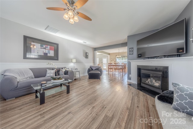 living room featuring hardwood / wood-style flooring and ceiling fan