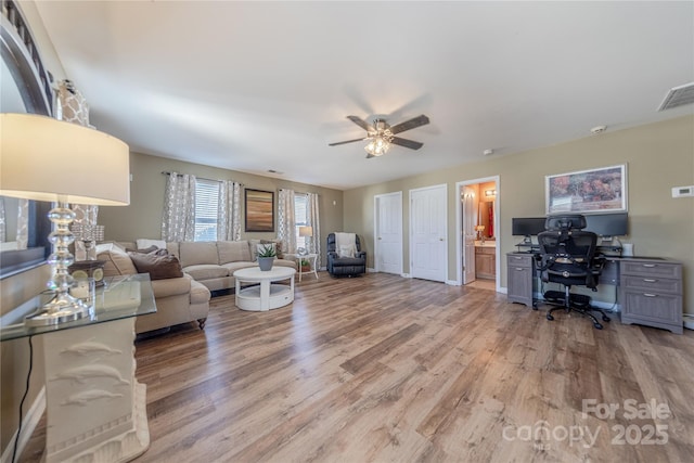 living room with ceiling fan and light wood-type flooring