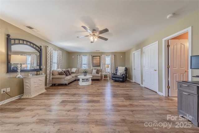 unfurnished living room with ceiling fan and light wood-type flooring