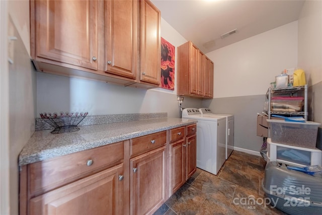 laundry room featuring cabinets and washing machine and dryer