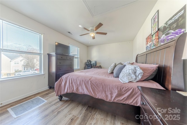 bedroom with light hardwood / wood-style flooring and ceiling fan