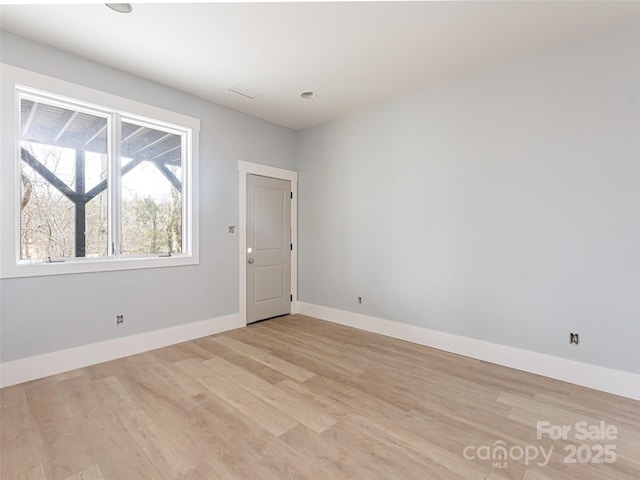 empty room with light hardwood / wood-style floors