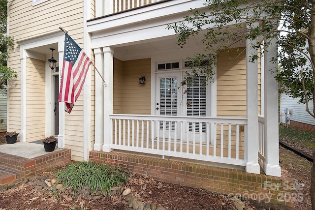 view of exterior entry with covered porch