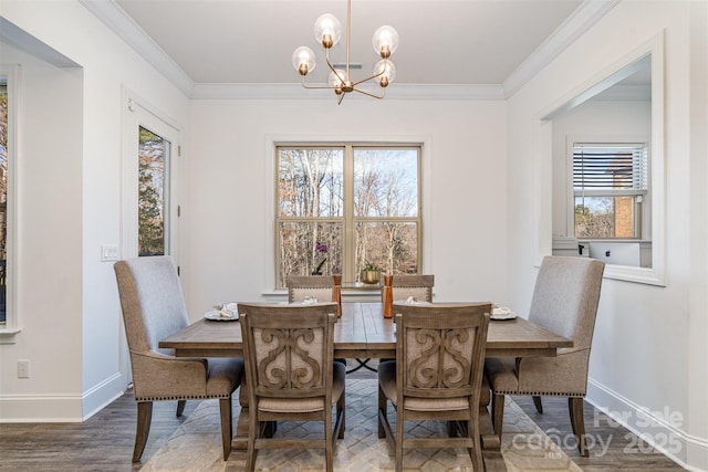 dining space with a notable chandelier, crown molding, baseboards, and wood finished floors