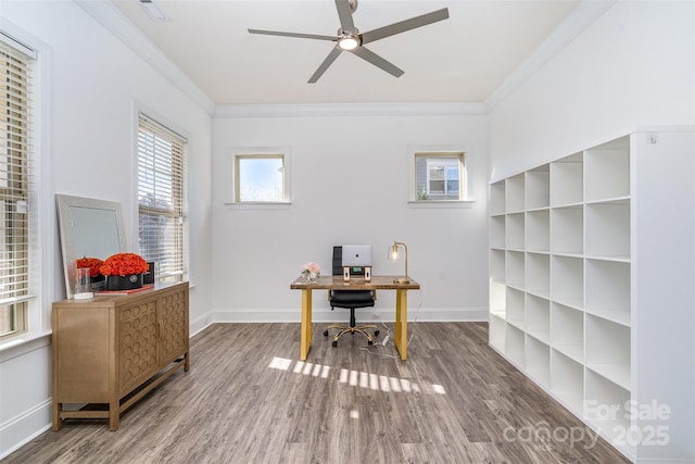 office space featuring ceiling fan, crown molding, baseboards, and wood finished floors