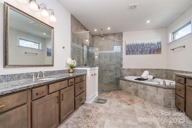 full bath with a stall shower, visible vents, vanity, a bath, and recessed lighting