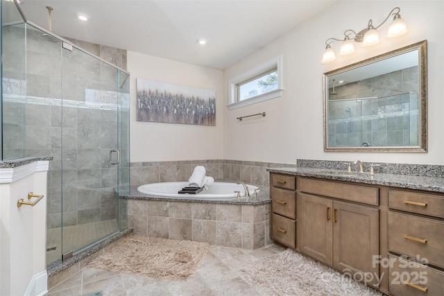 bathroom with recessed lighting, a garden tub, a shower stall, and vanity