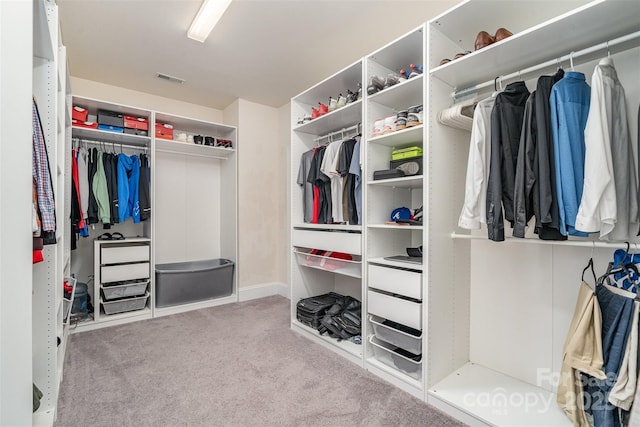 walk in closet with light carpet and visible vents