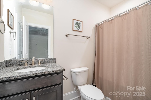 full bathroom featuring vanity and toilet