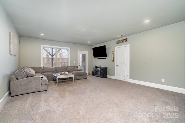 carpeted living room with recessed lighting and baseboards