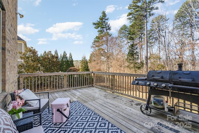 wooden deck with a grill