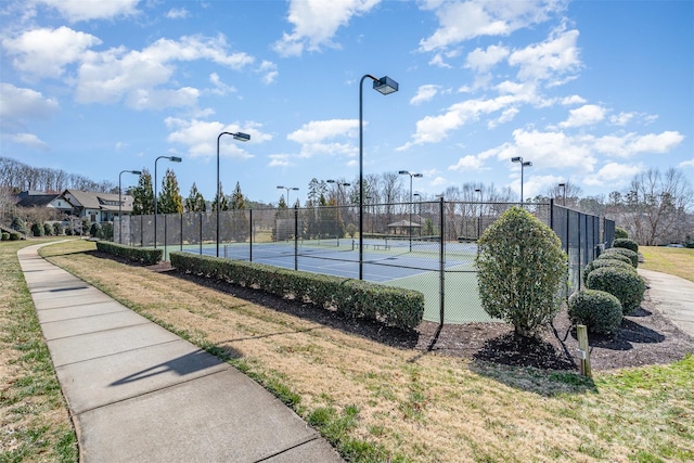 view of sport court featuring fence