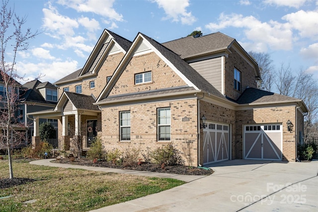 view of front of home with concrete driveway, brick siding, and roof with shingles