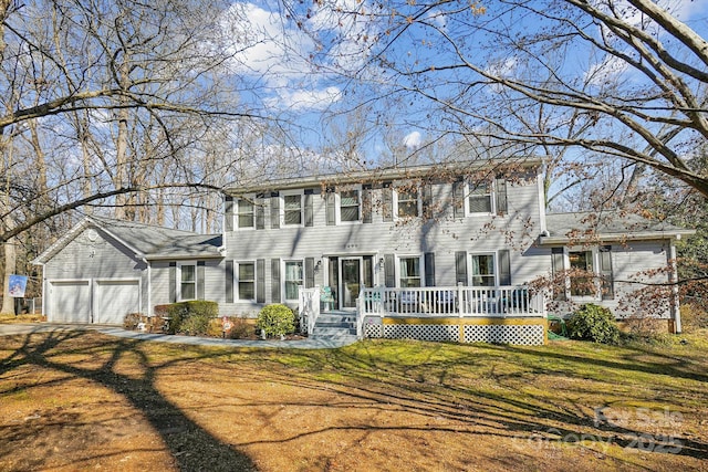 colonial home featuring a garage and a front yard