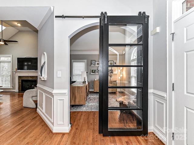 interior space featuring ornamental molding, hardwood / wood-style floors, and ceiling fan