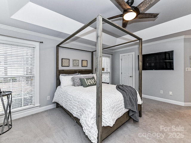 carpeted bedroom with ceiling fan and ornamental molding