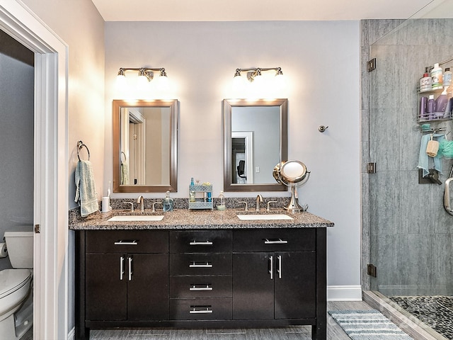 bathroom featuring walk in shower, vanity, and toilet