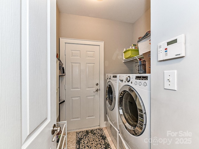 washroom featuring tile patterned flooring and washing machine and dryer