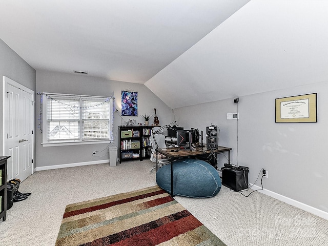 home office with lofted ceiling and carpet floors