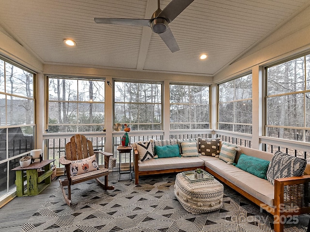 sunroom / solarium with lofted ceiling, a wealth of natural light, and ceiling fan