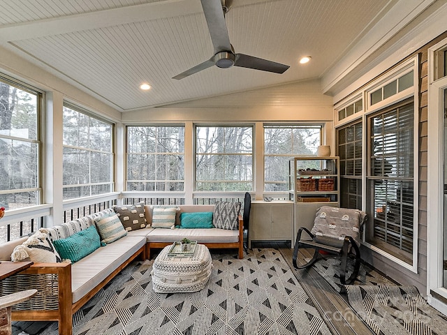 sunroom / solarium with lofted ceiling with beams, a wealth of natural light, and ceiling fan