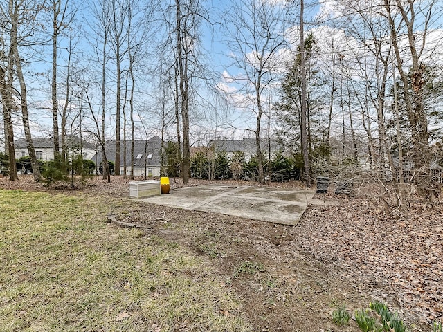 view of yard with basketball hoop