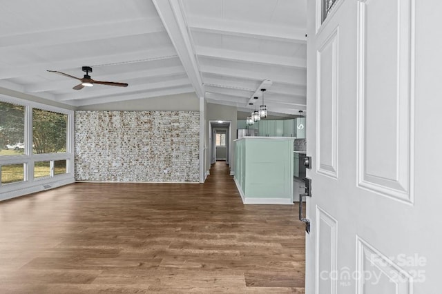 interior space featuring lofted ceiling with beams, dark wood-type flooring, and ceiling fan