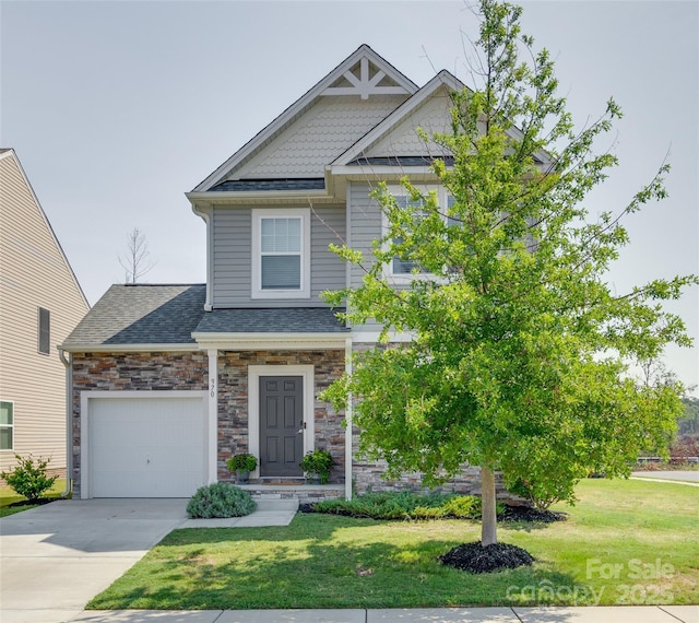 craftsman inspired home with a garage and a front yard