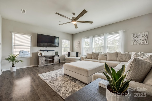 living room featuring dark wood-type flooring and ceiling fan