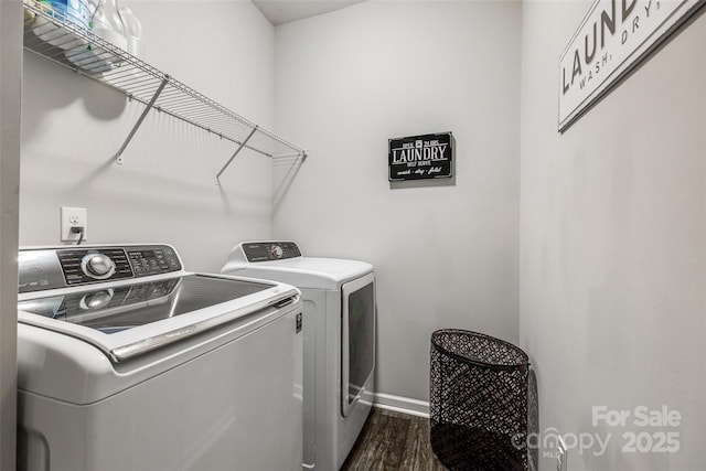 clothes washing area featuring washer and clothes dryer and dark hardwood / wood-style floors