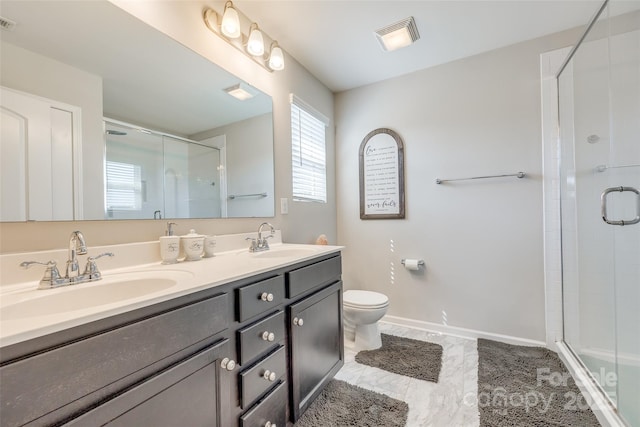 bathroom with vanity, a shower with door, and toilet