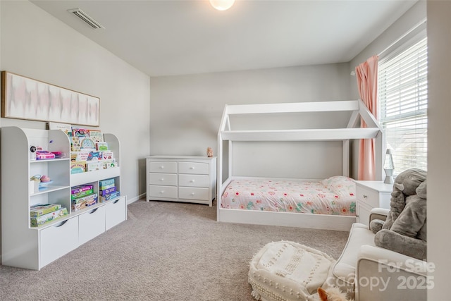 carpeted bedroom featuring a crib