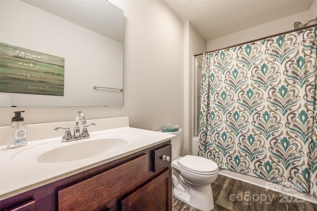 bathroom with vanity, hardwood / wood-style floors, and toilet