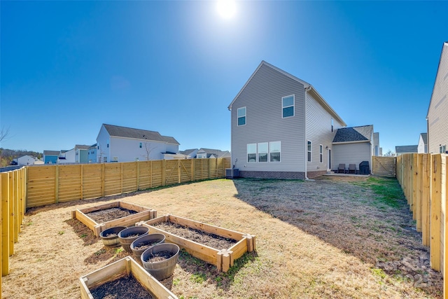 back of property featuring central AC and a lawn