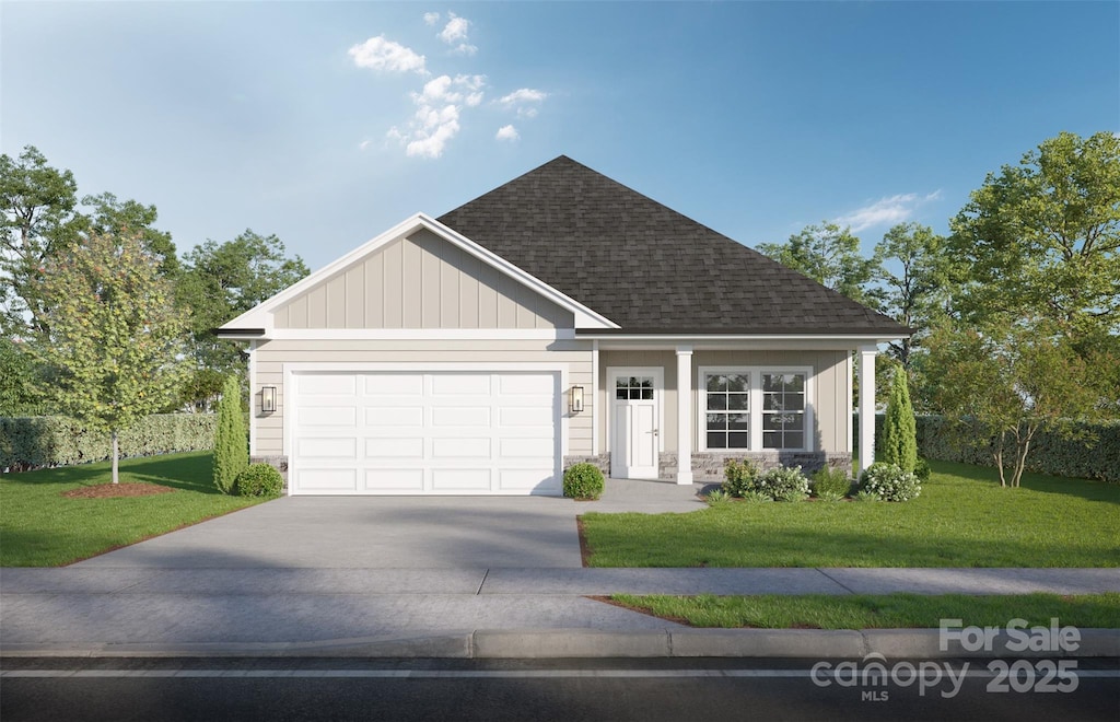 view of front of property with a garage and a front lawn