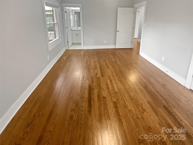 empty room with hardwood / wood-style flooring